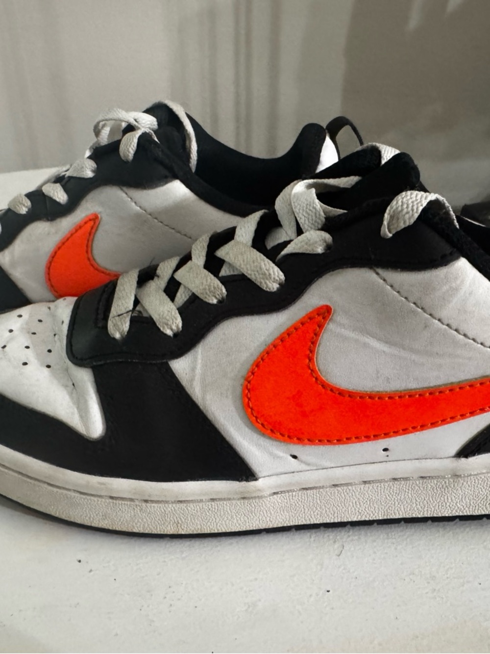 Nike Kids Black White Sneakers with Orange Swoosh